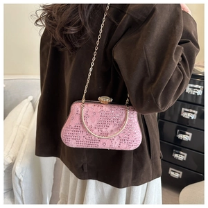 Macro detail of pink lace evening bag with sparkling rhinestones and golden handle
