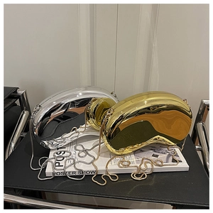 Detailed view of glossy gold and silver cashew-shaped evening clutch bags with chain straps