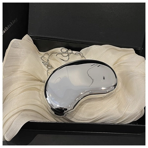 Polished silver bean-shaped acrylic clutch bag with chain inside a premium gift box