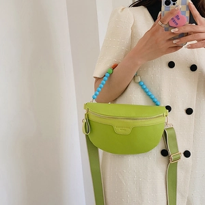 Bright green crescent crossbody bag with multi-color bead handle and wide fabric strap