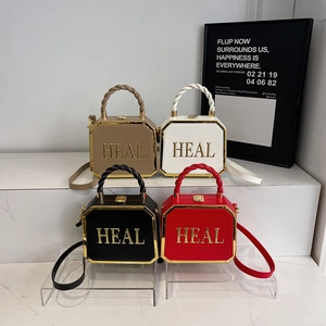 Octagonal box bags in four colors with gold HEAL lettering and detachable straps