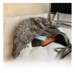 Macro shot of spacious sequin crossbody bag interior showing room for tablet and essentials