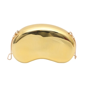 Sleek gold bean-shaped hard shell evening clutch with polished mirror finish and chain strap