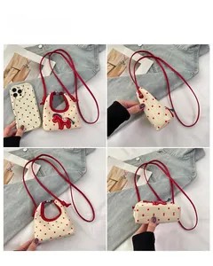 Detailed views of mini white canvas crossbody bag with red polka dots and pony patch