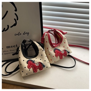 Detail of canvas mini bags with pony embroidery and leather trim in polka dot patterns