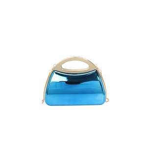 Metallic blue acrylic evening handbag with gold circular handle and detachable chain strap