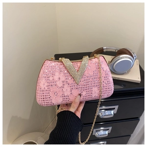 Close-up of pink sequin lace clutch with gold chain and V-shaped rhinestone buckle detail