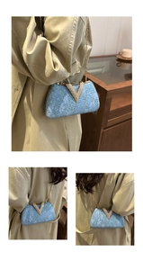 Detail of light blue lace evening bag with sequins, gold V-clasp and fine chain strap