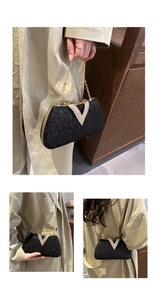 Detail of black rhinestone dinner bag with gold V clasp and metal chain strap