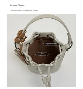 Macro view of beige leather bucket bag interior with brown lining and zipper pocket