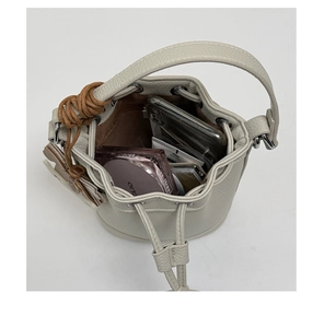 Top view of cream bucket bag interior showing capacity for phone and cosmetics