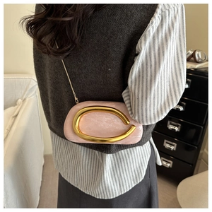 Detailed view of pink evening clutch with gold chain strap and C-shape metal hardware