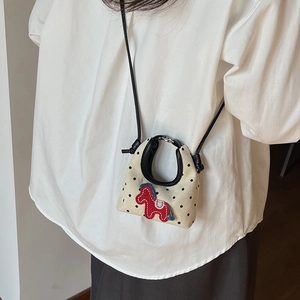 Cream canvas mini crossbody bag with black polka dots and red pony embroidery