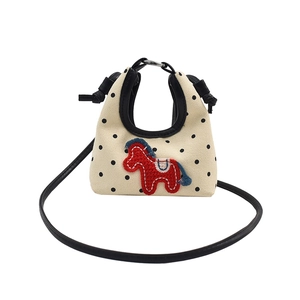 Mini canvas crossbody bag with black polka dots and red pony embroidery on white