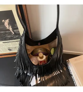 Internal view of a black fringed hobo bag showing spacious lining and a zipper pocket