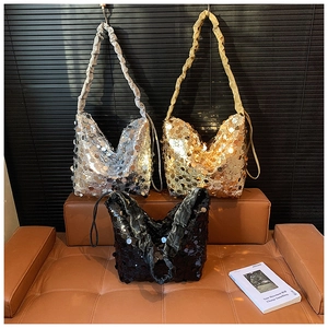 Detail of sequin shoulder bags in silver and gold with stylish pleated cloud straps