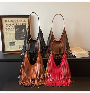 Detail of four multi-colored tassel hobo bags in black, brown, caramel, and red colors