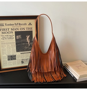 Detailed view of brown bohemian fringe hobo bag with long leather tassels and strap