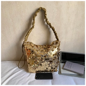Detail of shimmering gold sequin shoulder bag with stylish ruched cloud handle