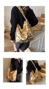 Close-up of sparkling gold sequins and pleated silk handle on the hobo bucket bag