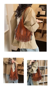 Detailed view of a brown tassel bucket bag with layered bohemian fringe and slim strap