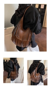 Detailed view of bohemian dark brown tassel shoulder bag with hobo bucket design