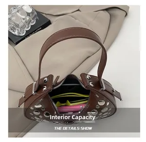 Top view of brown studded leather bag interior showing capacity for phone and sunglasses