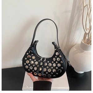 Detail of black leather hobo bag with silver metallic studs and double zipper design