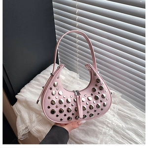 Close-up of pink leather hobo bag with silver rivets and long tassel zipper detail
