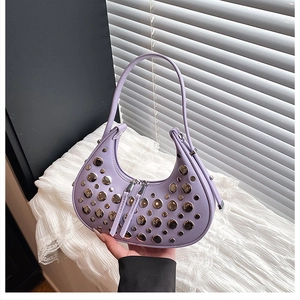 Close-up of light purple crescent bag with silver stud rivets and double zip closure
