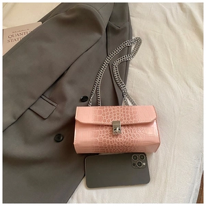 Pink faux leather snakeskin chain bag shown with a smartphone for size reference