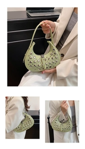 Detail of mint green crescent bag with silver studs and polished leather texture