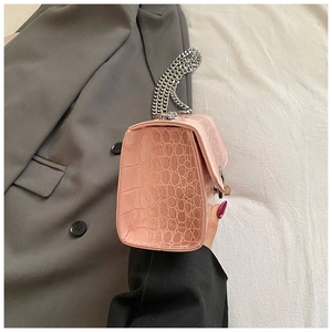 Detailed side view of pink faux leather square bag with crocodile pattern and silver chain