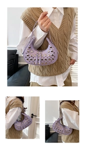 Detail of lavender crescent bag with silver rivets and smooth zipper closure
