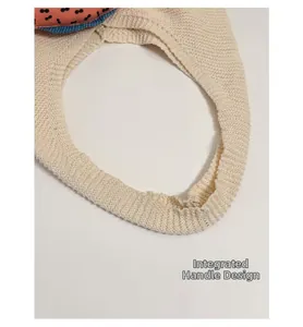 Detailed close-up of the integrated handle design on this knit fish pattern tote bag