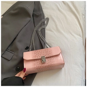 Close-up of gradient pink snakeskin pattern bag with silver chain and metal twist lock