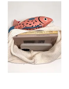 Vertical top view showing large interior capacity of the knit tote bag with items