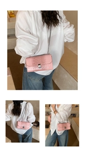 Detailed view of pink gradient snakeskin texture with silver chain and metal lock