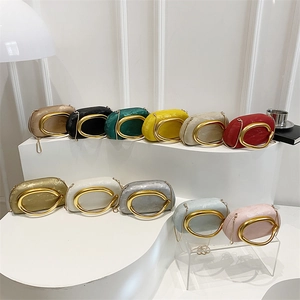 Elegant oval clutch bags with gold C-shaped handles in multiple colors for evening parties