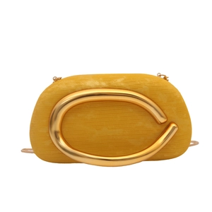 Elegant bright yellow evening clutch bag with round fabric body and C-shaped gold metal buckle