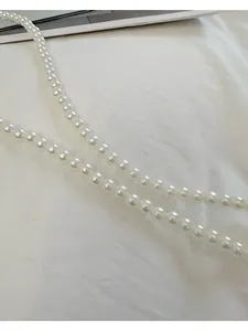 Détail de la bandoulière en perles rondes blanches pour sacs à main élégants