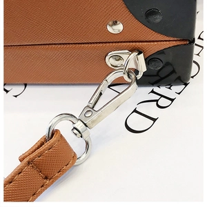 Détail du sac radio vintage en cuir marron grainé avec boucle en métal argenté