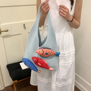 Cute Japanese knit tote bag with 3D colorful fish pattern carried by woman in dress