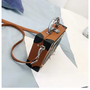 Gros plan d'un sac bandoulière style radio vintage avec texture cuir et poignée métal