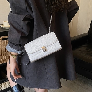 Chic white faux leather crossbody bag with crocodile pattern and silver chain strap