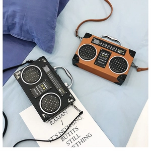 Gros plan de sacs à main rétro en forme de radio, cuir PU noir et marron, poignées métal