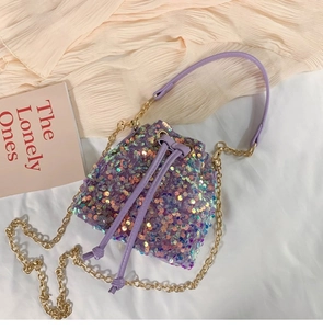 Detail of purple sequin bucket bag featuring drawstring closure and gold chain strap