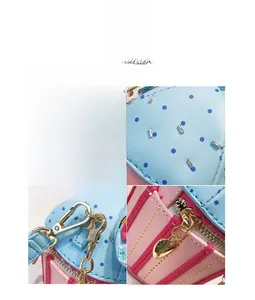 Detailed close-up of heart zipper, gold hardware and polka dot leather on handbag