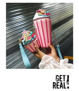 Close-up of creative ice cream cupcake crossbody bag with pink stripes and chain strap