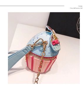 Detail of creative cupcake crossbody bag with pink bow, sequins and golden chain